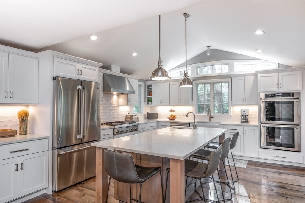 119 Gayland Road Needham, MA 02492 - Photo 4 of 42 a kitchen with stainless steel appliances a dining table chairs stove and refrigerator