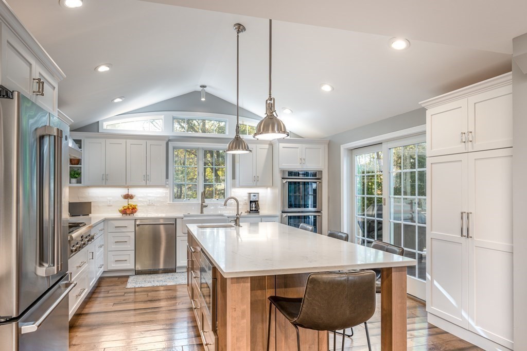 119 Gayland Road Needham, MA 02492 - Photo 5 of 42 a kitchen with stainless steel appliances granite countertop a stove a refrigerator a sink dishwasher and white cabinets with wooden floor