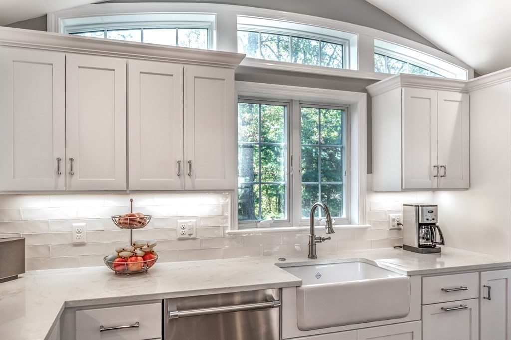 119 Gayland Road Needham, MA 02492 - Photo 7 of 42 a kitchen with white cabinets and a window