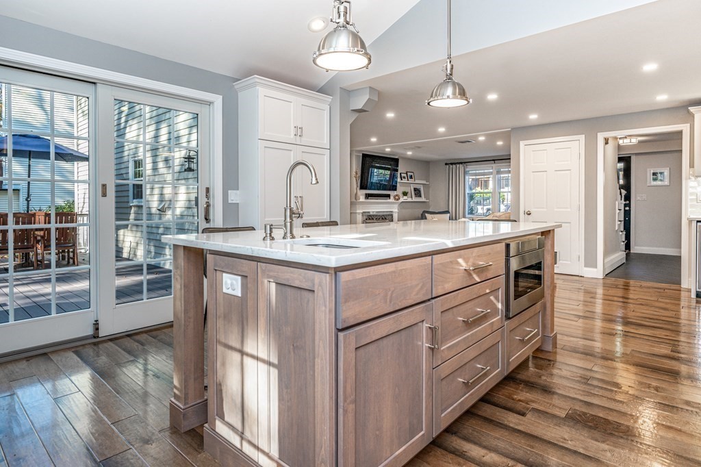 119 Gayland Road Needham, MA 02492 - Photo 9 of 42 a kitchen with stainless steel appliances granite countertop a sink cabinets and wooden floor