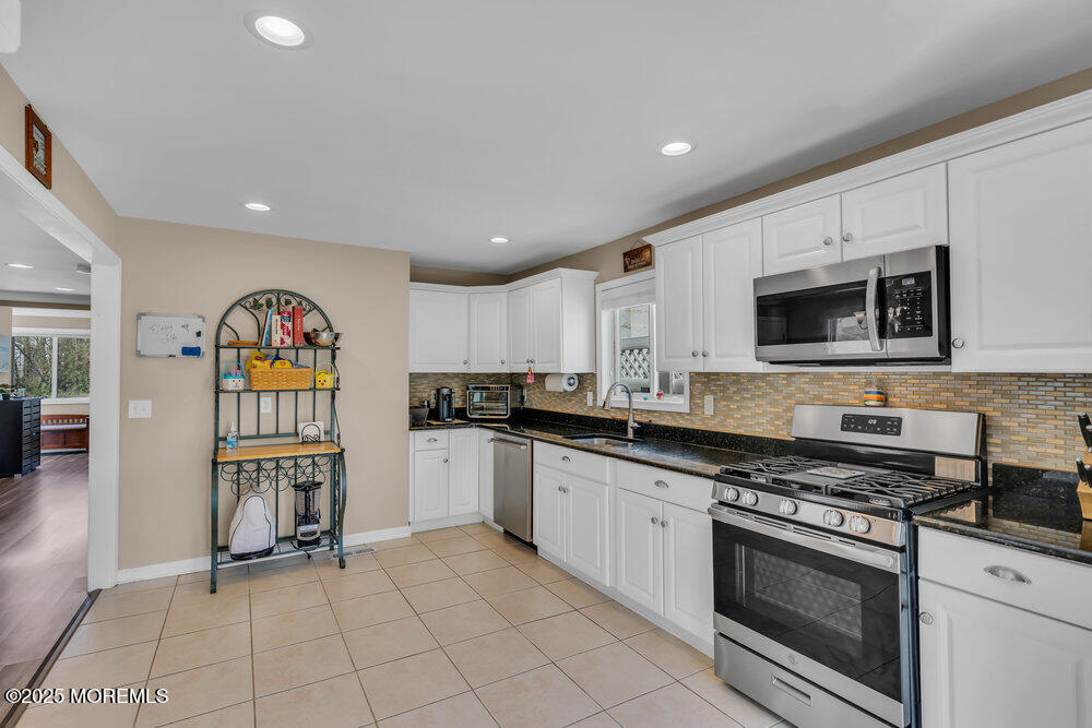 108 Maple Place Keyport, NJ 07735 - Photo 11 of 26 a large kitchen with stainless steel appliances granite countertop a stove and a sink