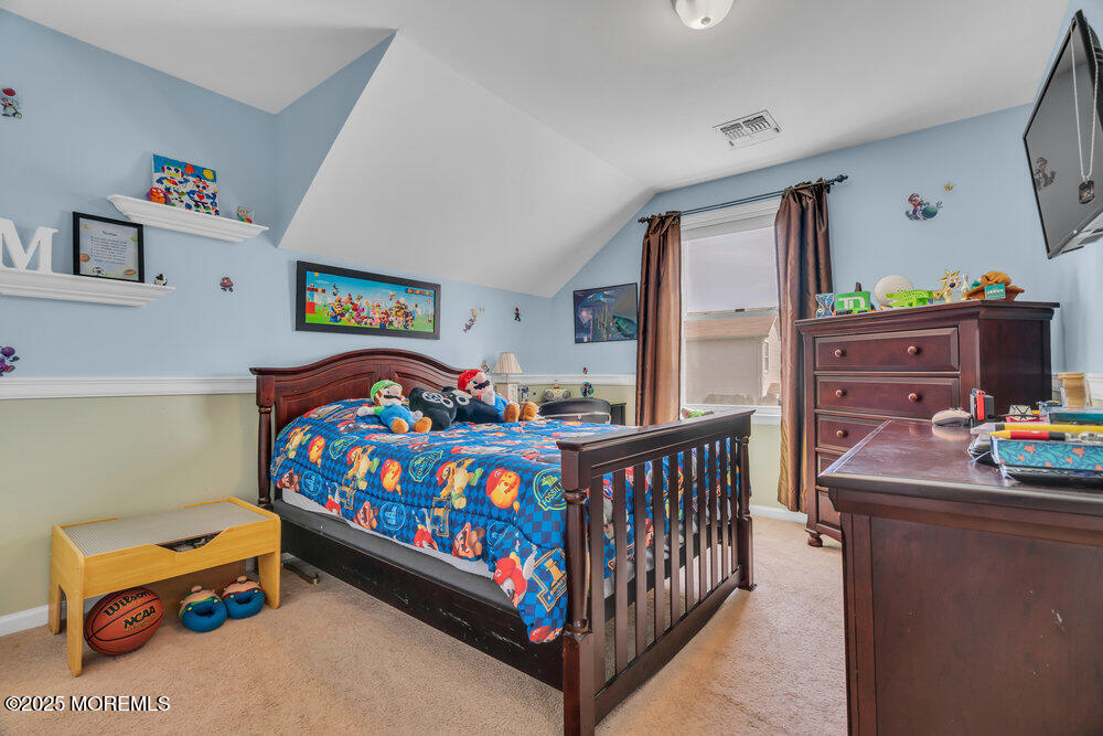 108 Maple Place Keyport, NJ 07735 - Photo 19 of 26 a bedroom with furniture a baby crib and a window