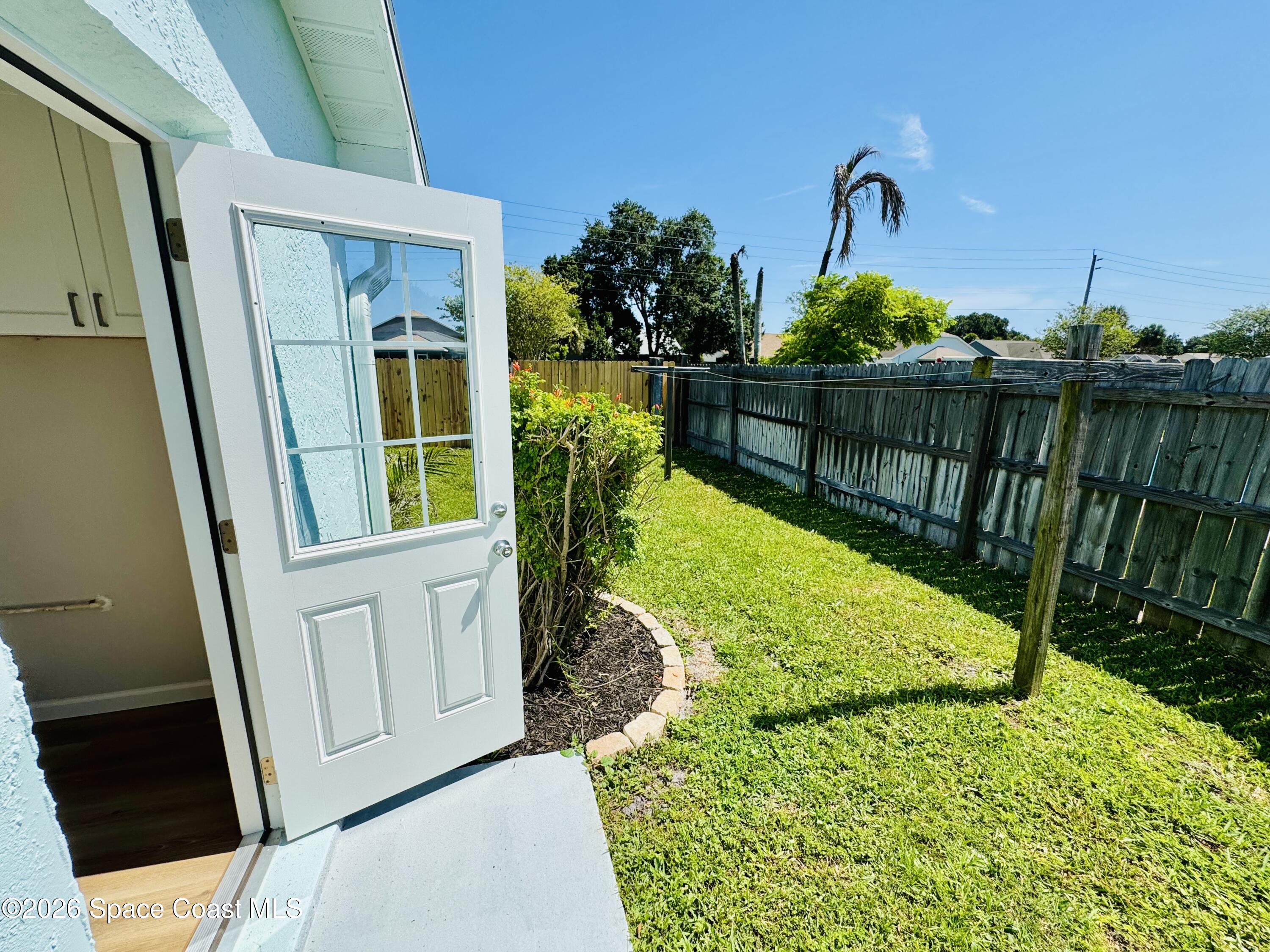 1910 Tallridge Road Melbourne, FL 32935 - Photo 23 of 34 Back yard from laundry door