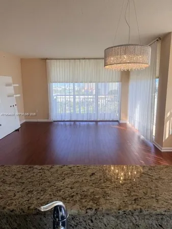 a view of a room with wooden floor and windows