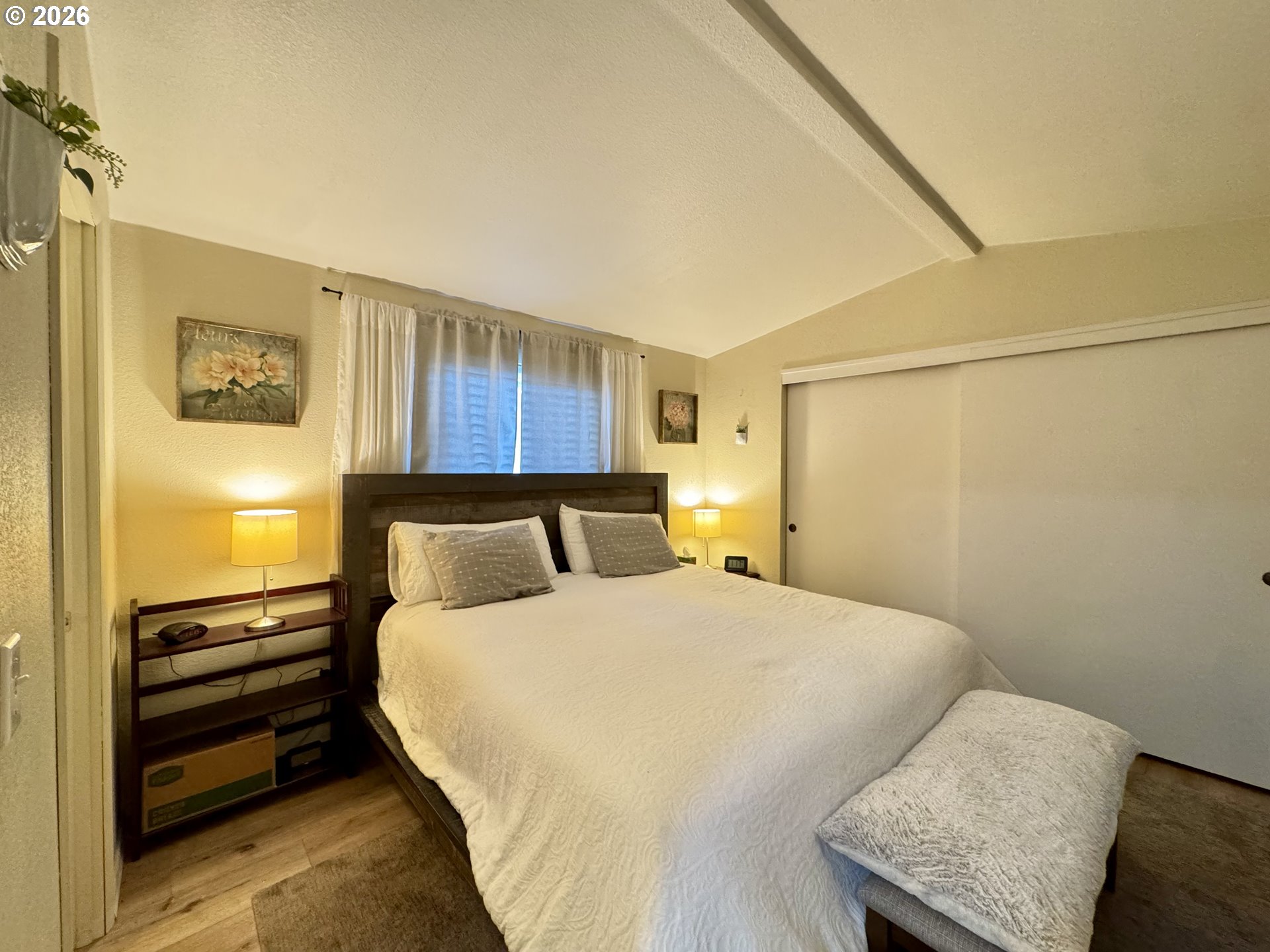 3760 Highway 101, Unit 1 Florence, OR 97439 - Photo 7 of 32 a bed room with a bed and a night stand