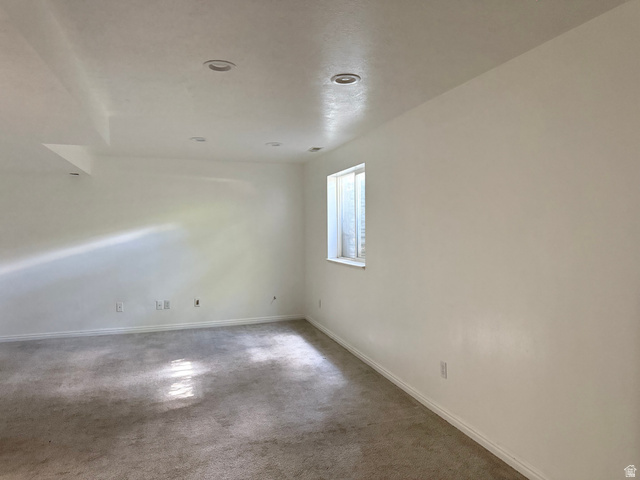44 Wapiti Loop Hyrum, UT 84319 - Photo 14 of 18 Spacious room featuring neutral carpeting, a single window, white walls, and recessed ceiling lighting