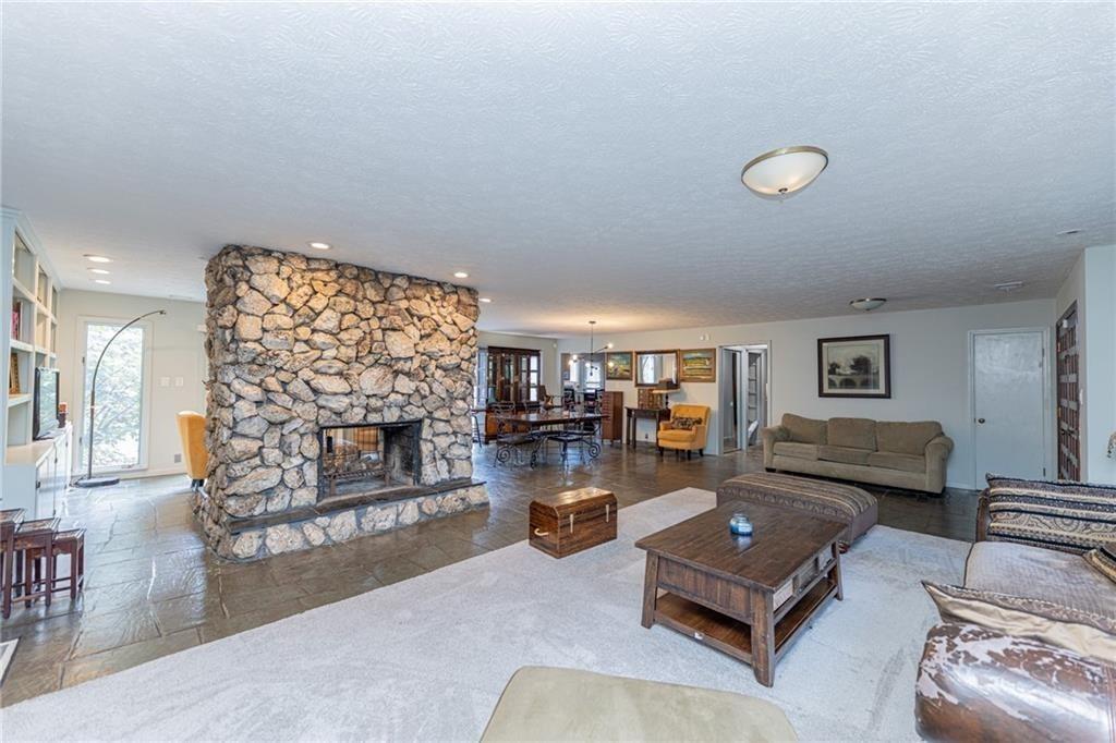 225 Banks Road Fayetteville, GA 30214 - Photo 12 of 26 a living room with furniture and a fireplace