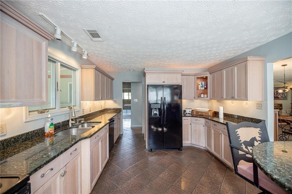 225 Banks Road Fayetteville, GA 30214 - Photo 16 of 26 a kitchen with granite countertop a refrigerator stove and sink