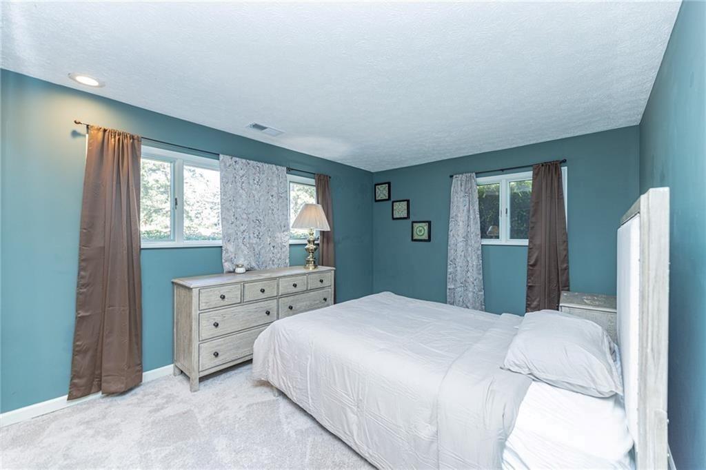 225 Banks Road Fayetteville, GA 30214 - Photo 17 of 26 a bedroom with a bed and a dresser