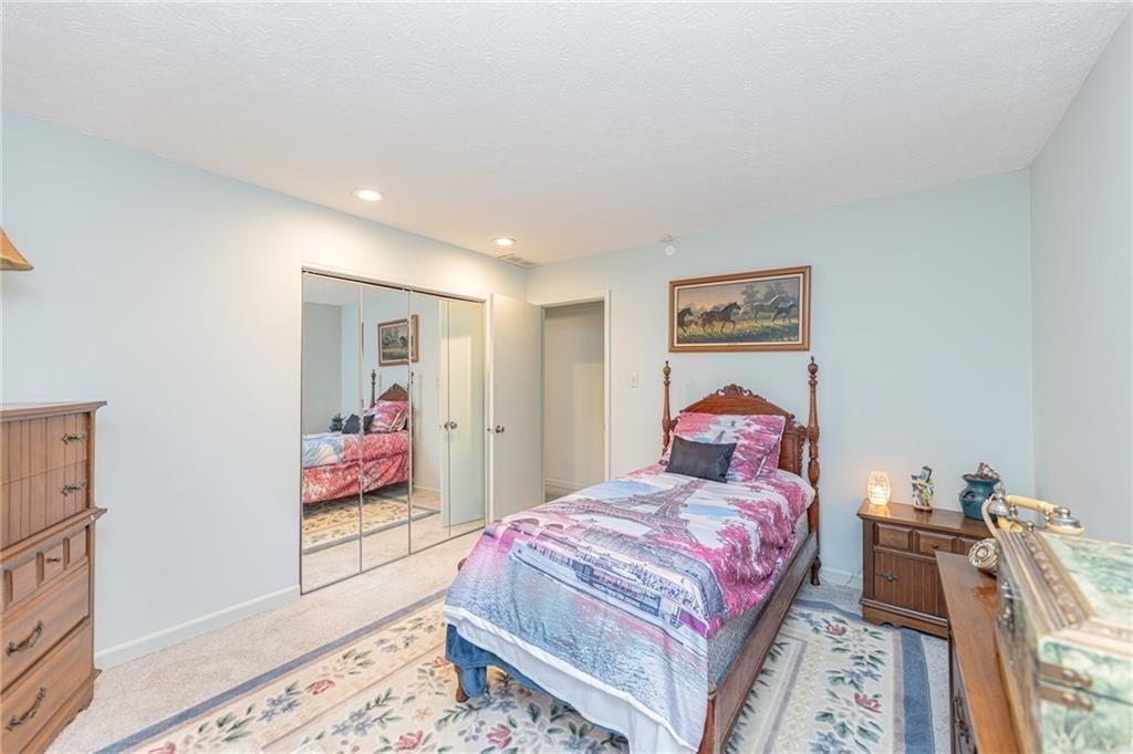 225 Banks Road Fayetteville, GA 30214 - Photo 19 of 26 a bedroom with a bed and a mirror