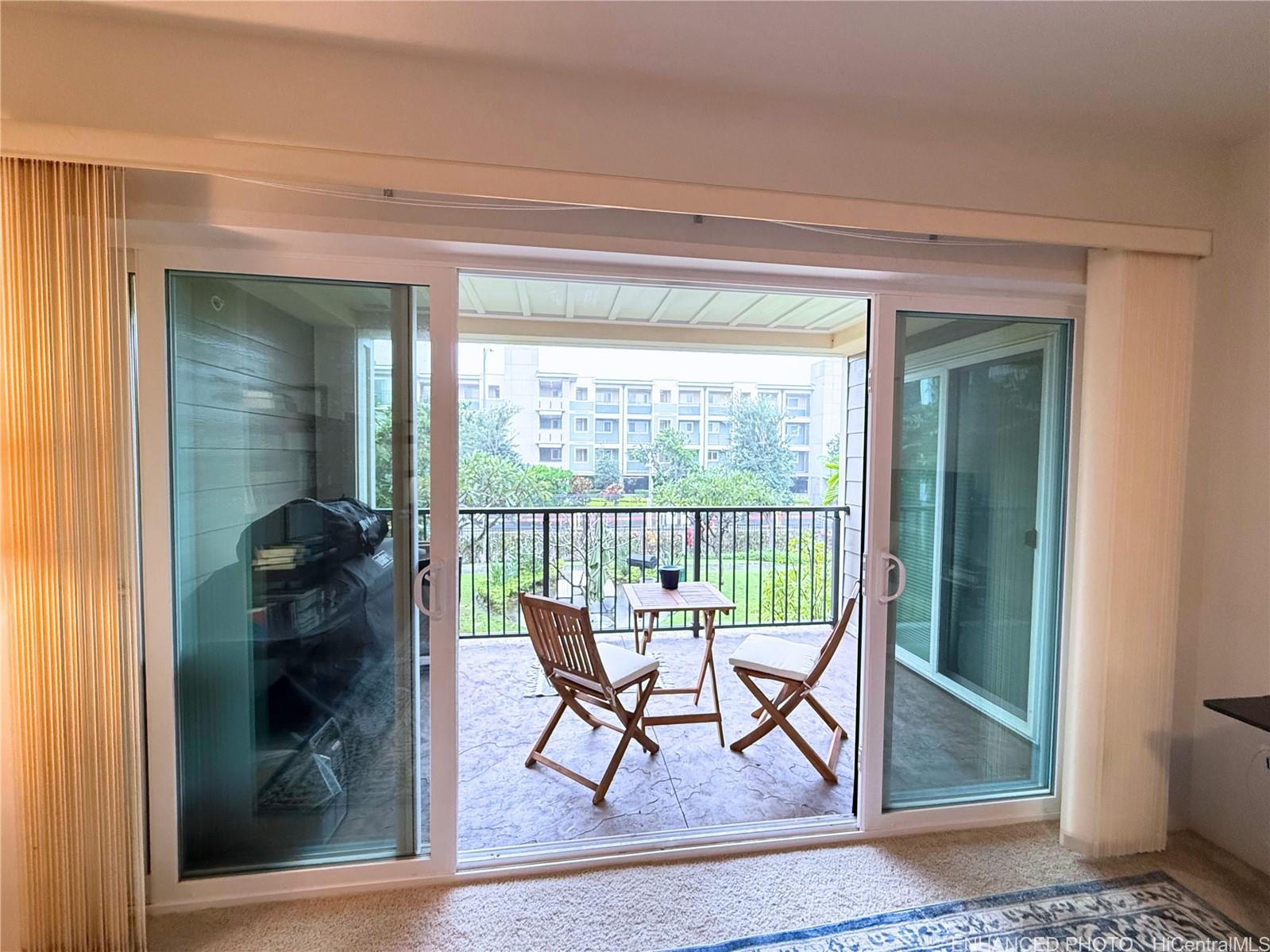 409 Kailua Road, Unit 7106 Kailua, HI 96734 - Photo 16 of 22 Enhanced - Lanai accessible through living room and primary bedroom. Views of courtyard, Aoloa Street, & Building 6.