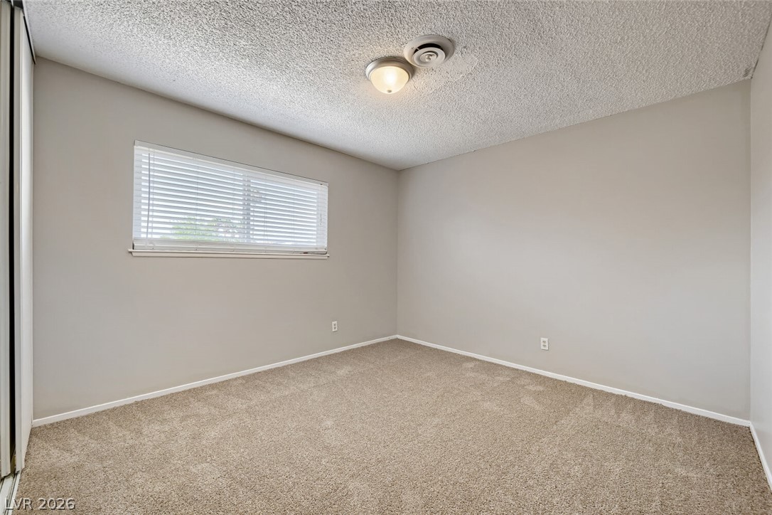 6321 Portola Road Las Vegas, NV 89108 - Photo 16 of 29 A well-lit bedroom provides a comfortable, inviting retreat.