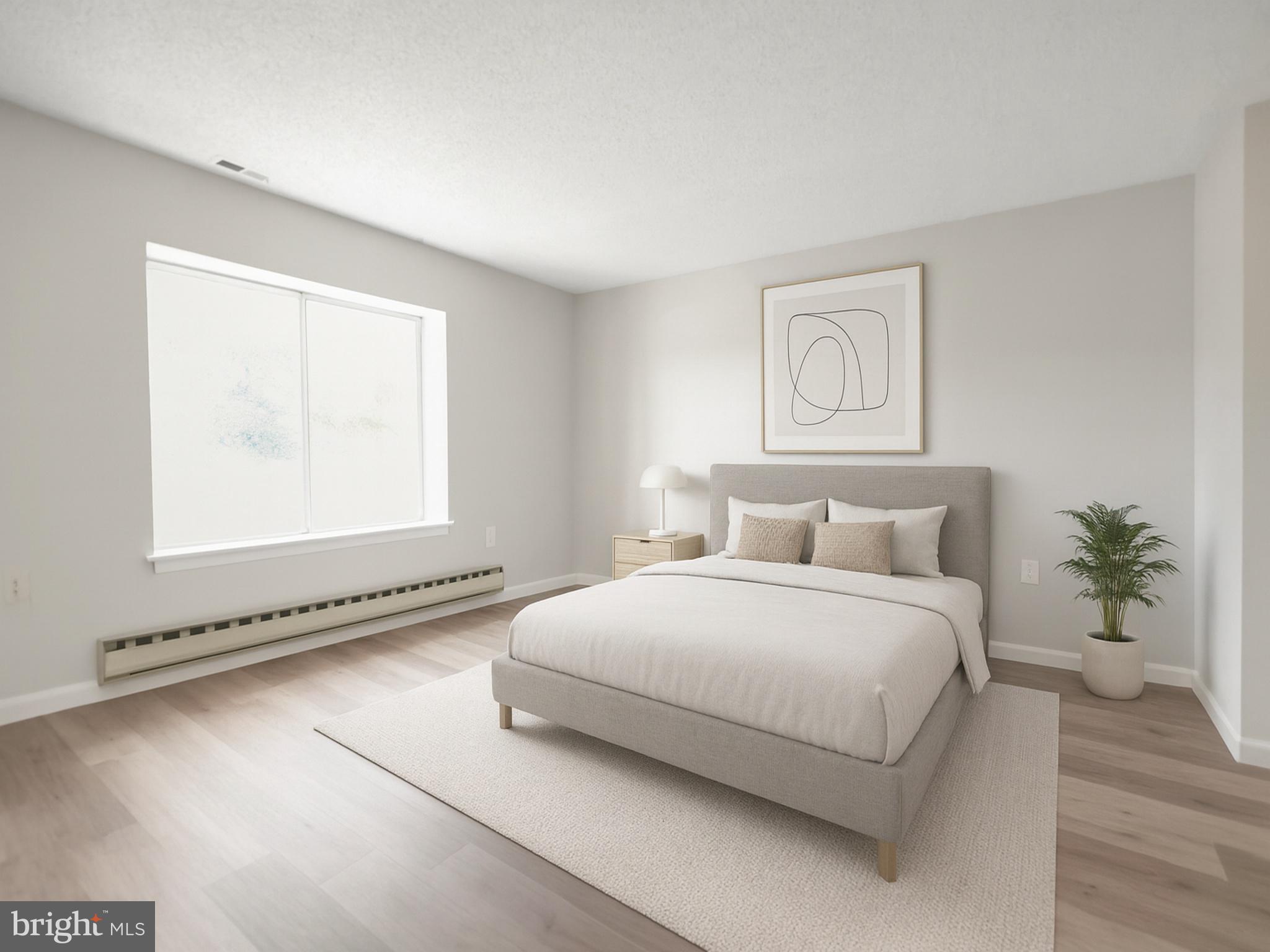 15121 Glade Drive, Unit 132F Silver Spring, MD 20906 - Photo 11 of 27 a bedroom with a bed and a window