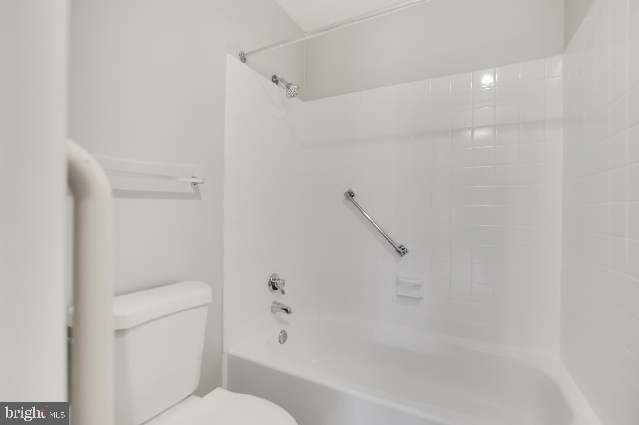 15121 Glade Drive, Unit 132F Silver Spring, MD 20906 - Photo 13 of 27 a bathroom with a shower and a toilet