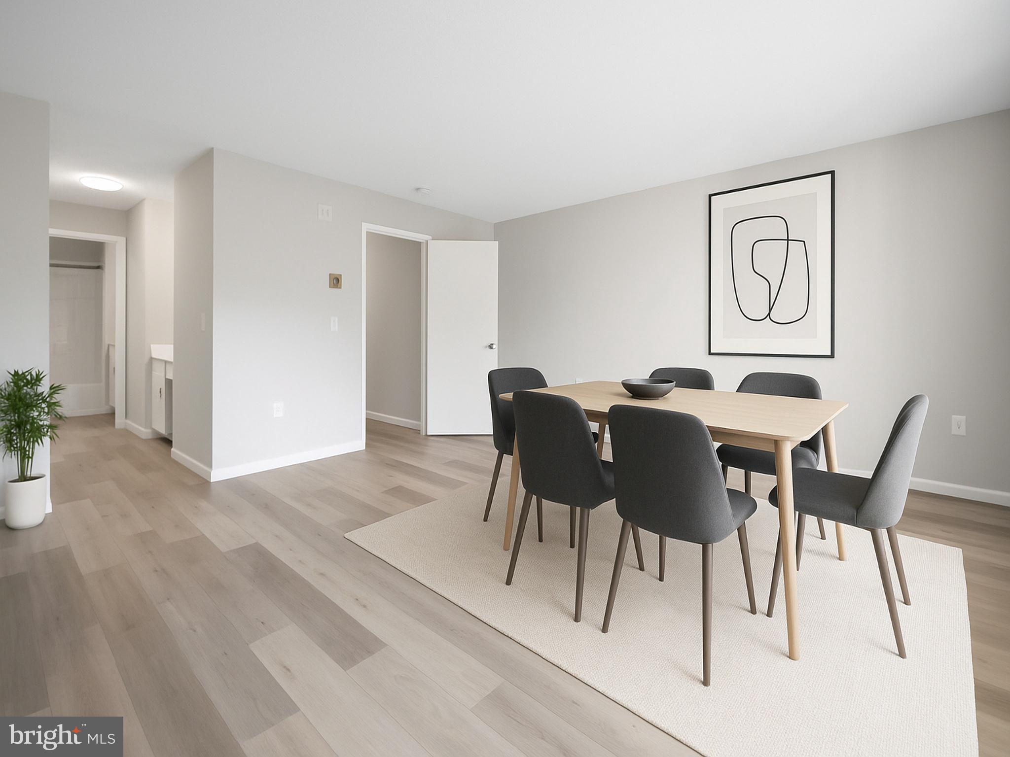 15121 Glade Drive, Unit 132F Silver Spring, MD 20906 - Photo 4 of 27 a view of a dining room with furniture and wooden floor