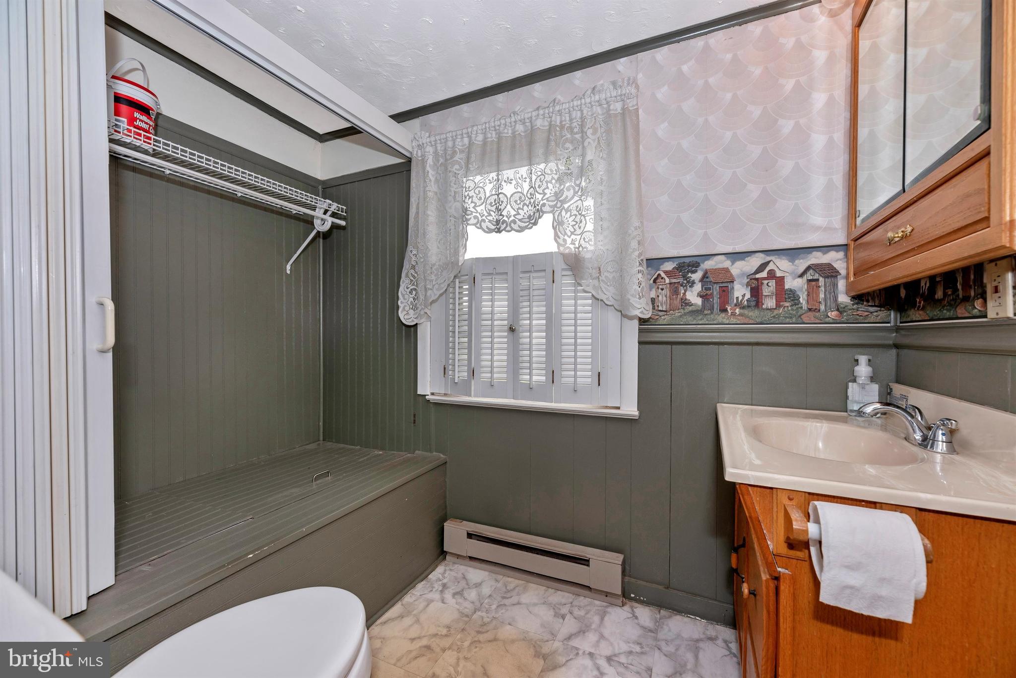 12030 Lookingbill Road Keymar, MD 21757 - Photo 40 of 58 Main level half bath-tub under shelving