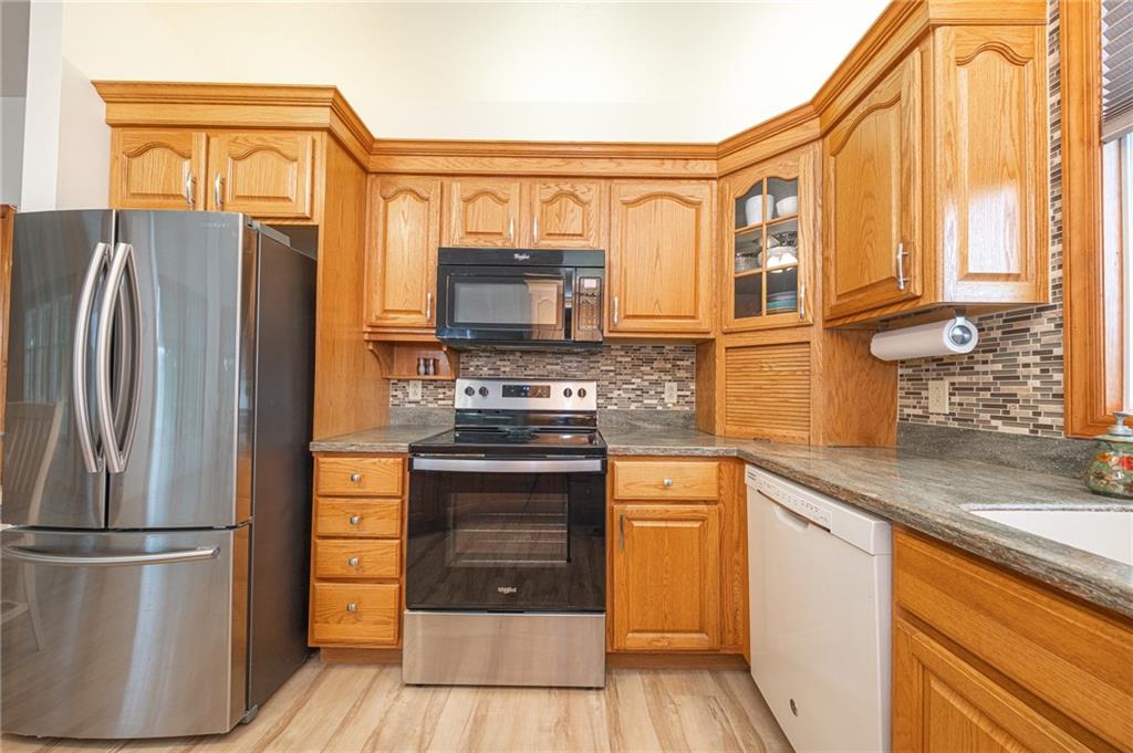 840 Old Millcreek Road Hookstown, PA 15050 - Photo 13 of 33 a kitchen with stainless steel appliances granite countertop a refrigerator a stove and a sink with wooden floor