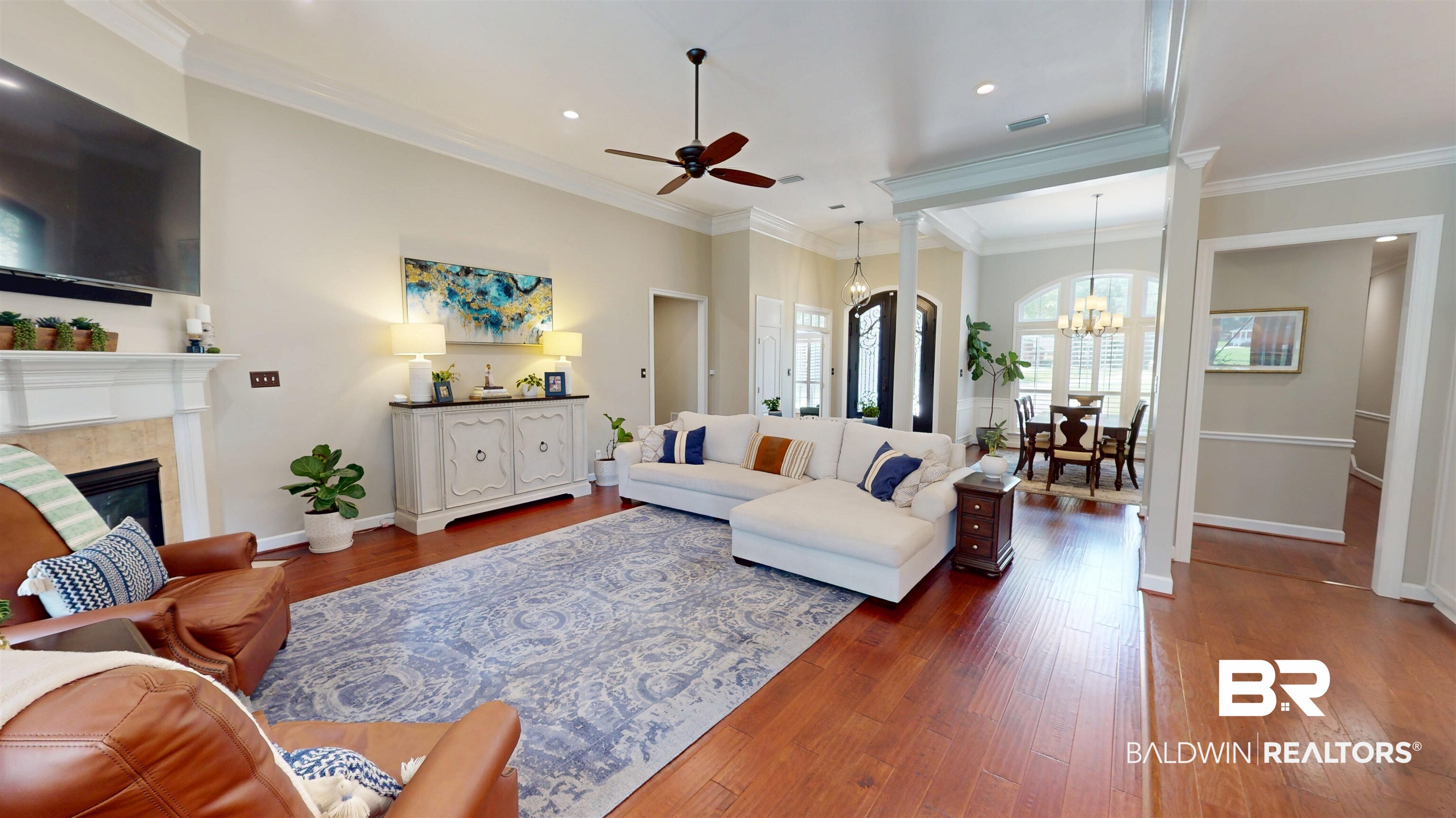 8775 Dawes Lake Road North Mobile, AL 36619 - Photo 22 of 59 Living area with a chandelier, a ceiling fan, dark wood-style flooring, crown molding, and a tile fireplace