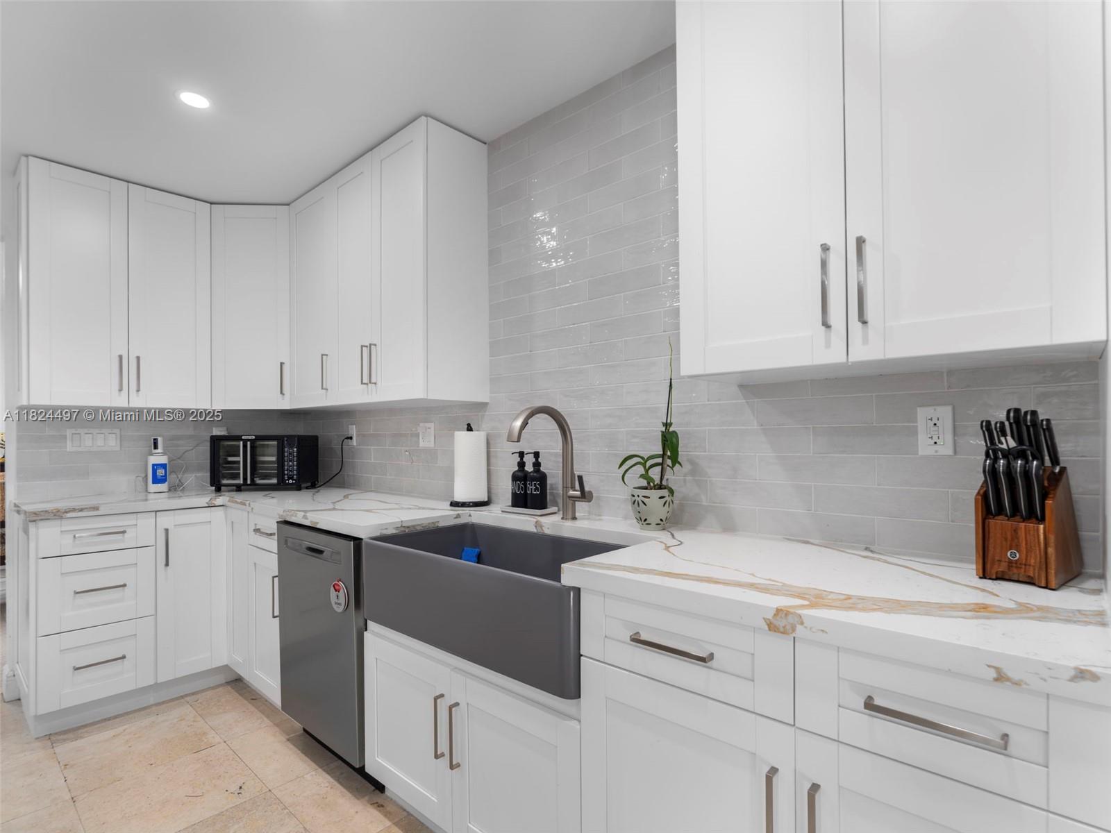 1851 Southwest 126th Court Miami, FL 33175 - Photo 14 of 85 a kitchen with white cabinets and white appliances