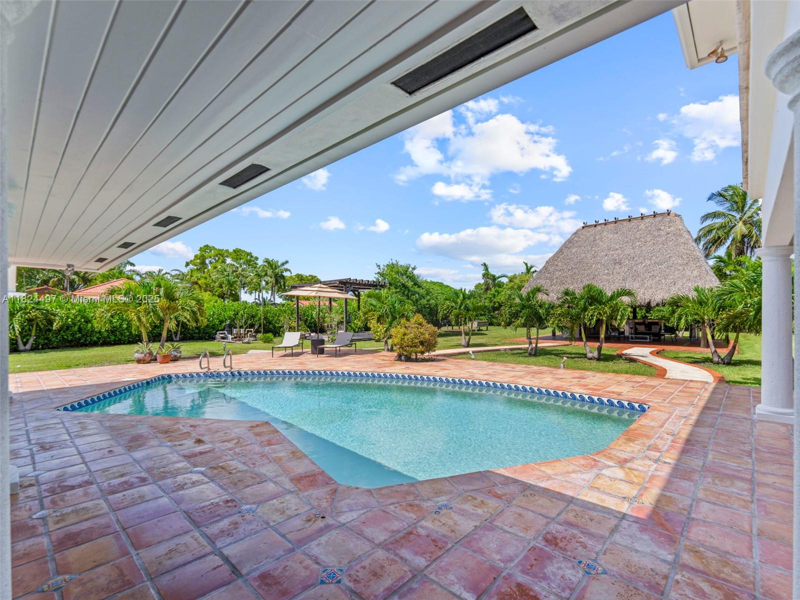 1851 Southwest 126th Court Miami, FL 33175 - Photo 30 of 85 a view of swimming pool with seating space and a swimming pool