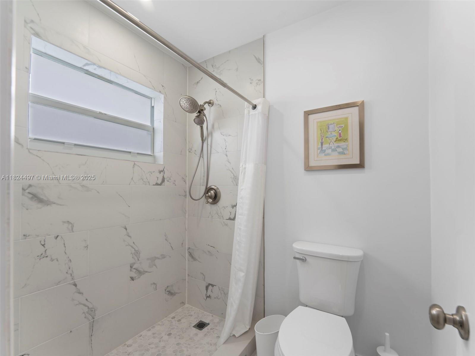 1851 Southwest 126th Court Miami, FL 33175 - Photo 48 of 85 a white toilet sitting next to a shower