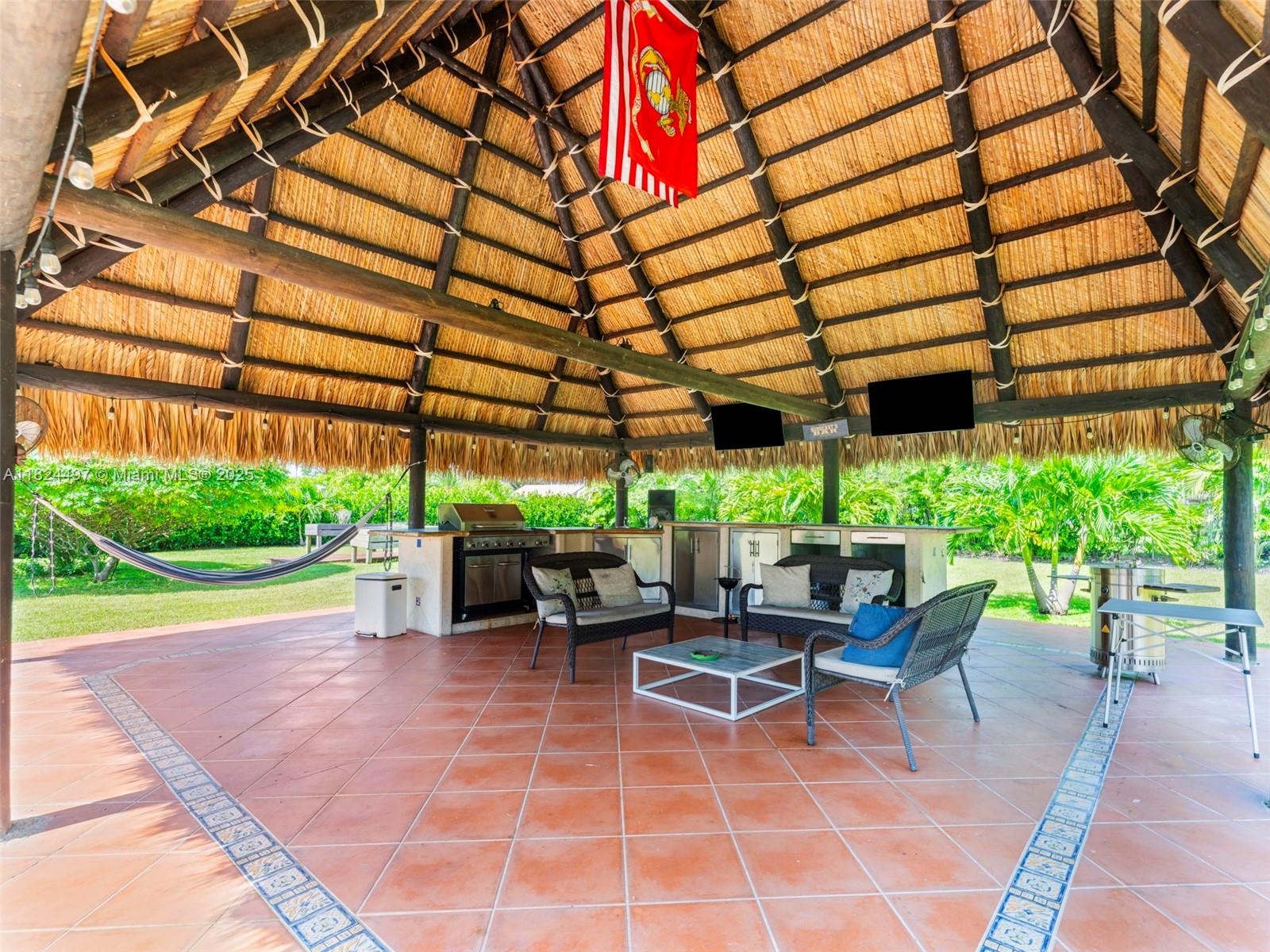 1851 Southwest 126th Court Miami, FL 33175 - Photo 74 of 85 a view of a patio with a table and chairs under an umbrella