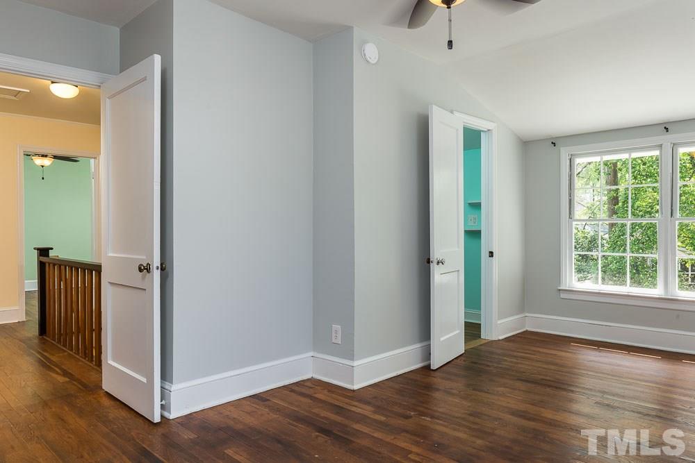 2113 Pine Drive Raleigh, NC 27608 - Photo 11 of 25 a view of an empty room with wooden floor and a window