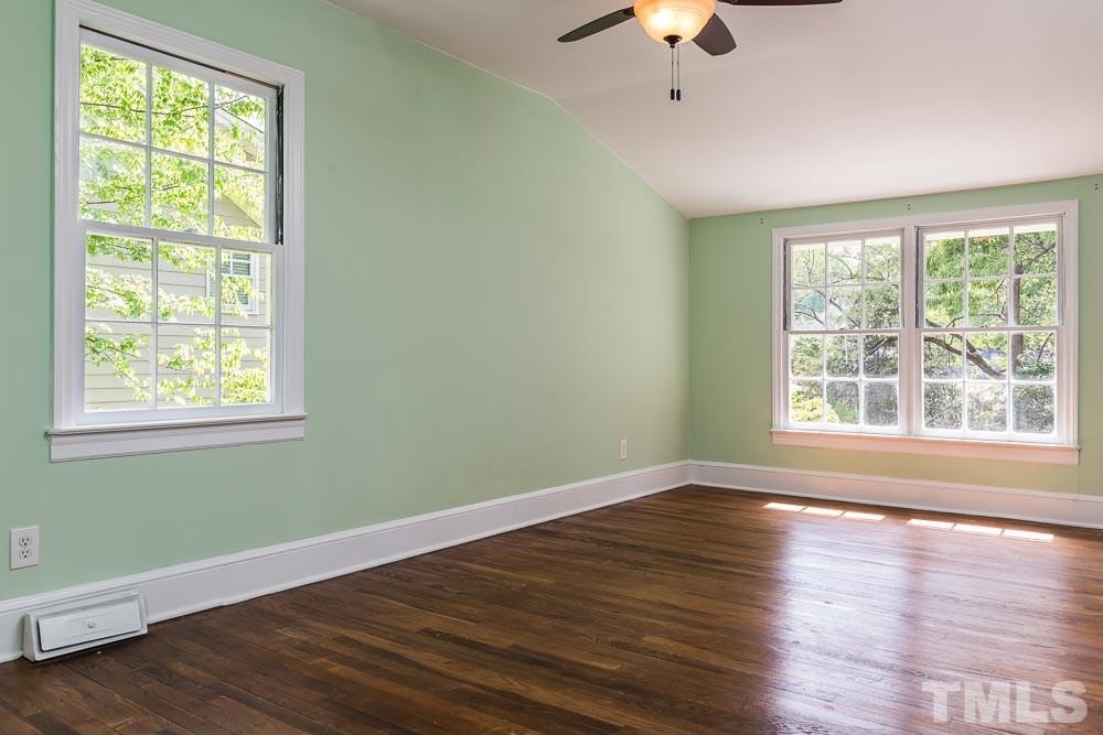 2113 Pine Drive Raleigh, NC 27608 - Photo 16 of 25 a view of an empty room with wooden floor and a window