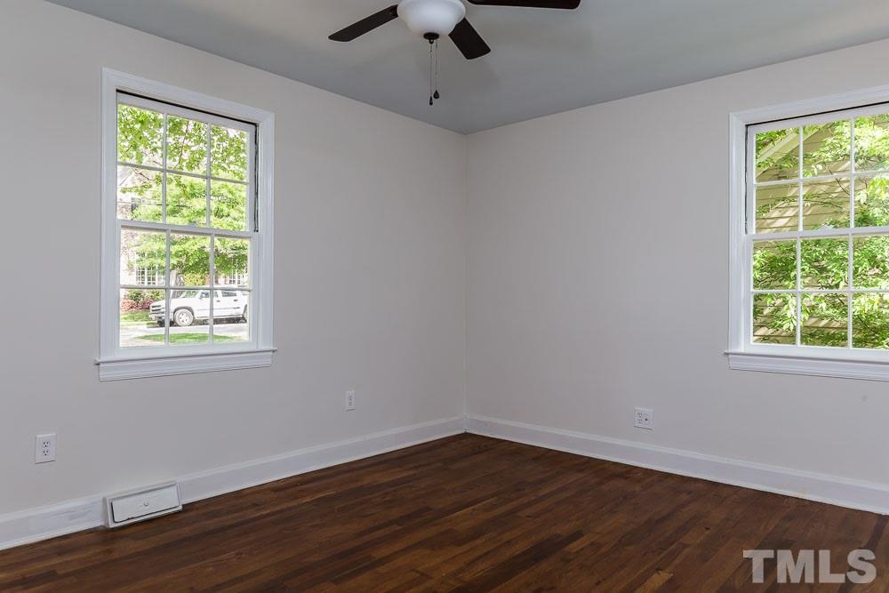 2113 Pine Drive Raleigh, NC 27608 - Photo 18 of 25 a view of an empty room with wooden floor and a window