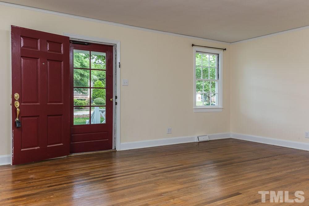 2113 Pine Drive Raleigh, NC 27608 - Photo 3 of 25 an empty room with wooden floor and windows