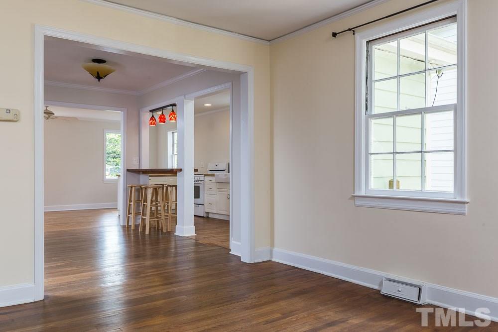 2113 Pine Drive Raleigh, NC 27608 - Photo 4 of 25 an empty room with wooden floor and windows