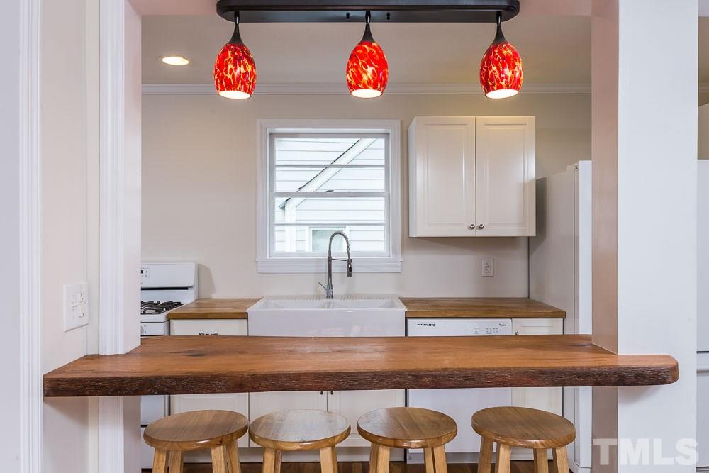2113 Pine Drive Raleigh, NC 27608 - Photo 6 of 25 a view of kitchen island with furniture and wooden floor