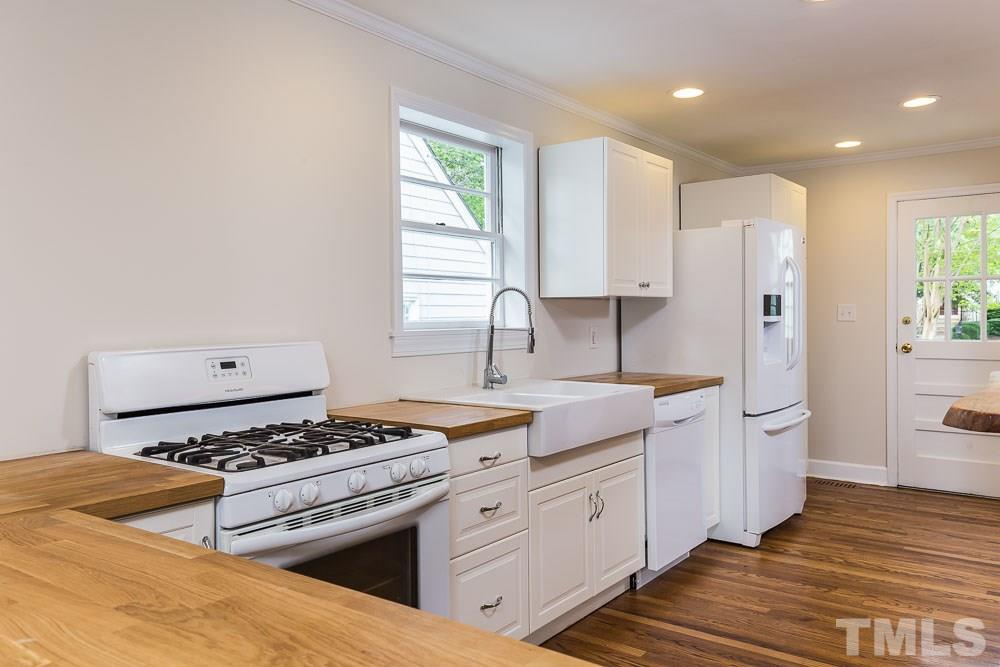 2113 Pine Drive Raleigh, NC 27608 - Photo 7 of 25 a kitchen with stainless steel appliances a sink dishwasher stove and refrigerator