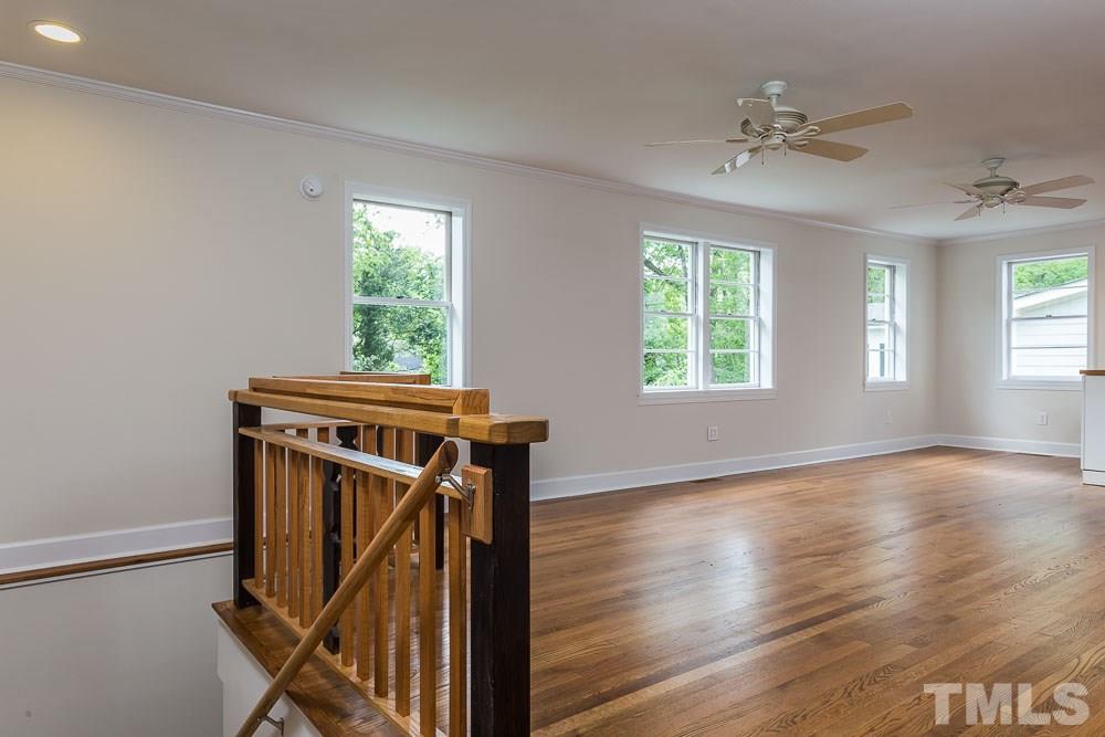 2113 Pine Drive Raleigh, NC 27608 - Photo 10 of 25 a view of a livingroom with wooden floor and window