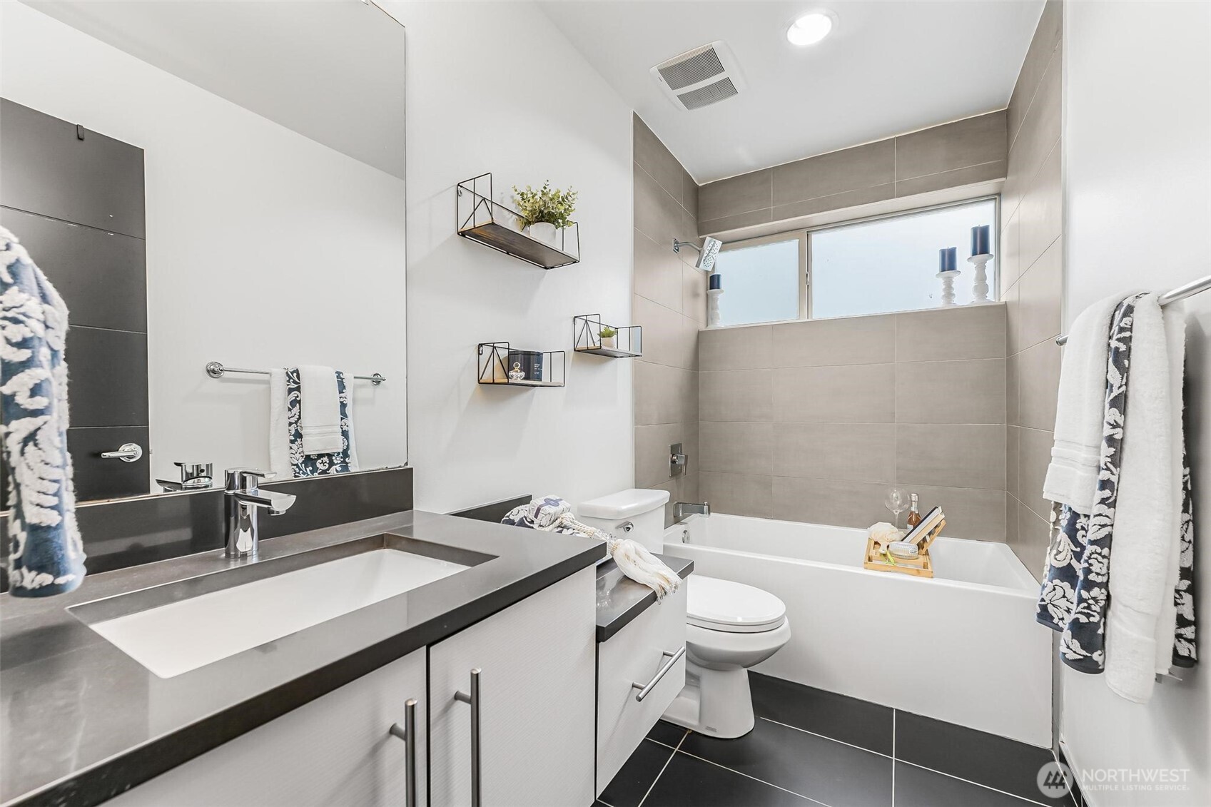 7748 Delridge Way Southwest Seattle, WA 98106 - Photo 15 of 22 a bathroom with a double vanity sink toilet and shower