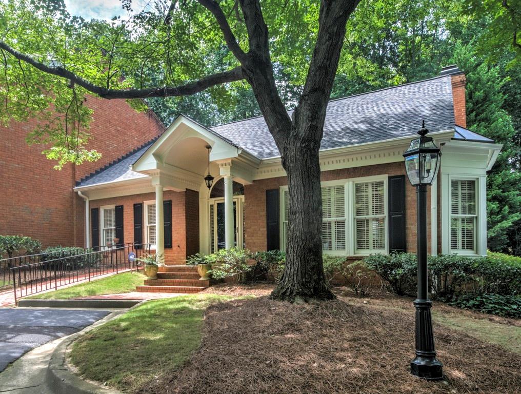 3075 Howell Mill Road Northwest, Unit 13 Atlanta, GA 30327 - Photo 1 of 1 a front view of a house with yard and green space