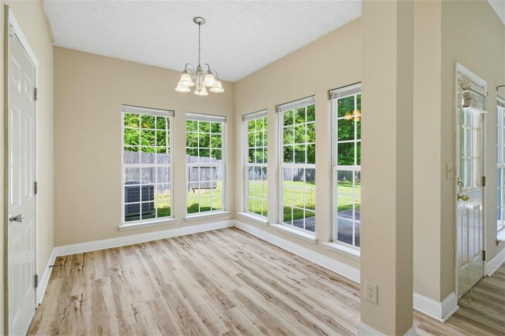 1231 Hillview Road Hampton, GA 30228 - Photo 4 of 49 a view of an empty room with wooden floor and a window