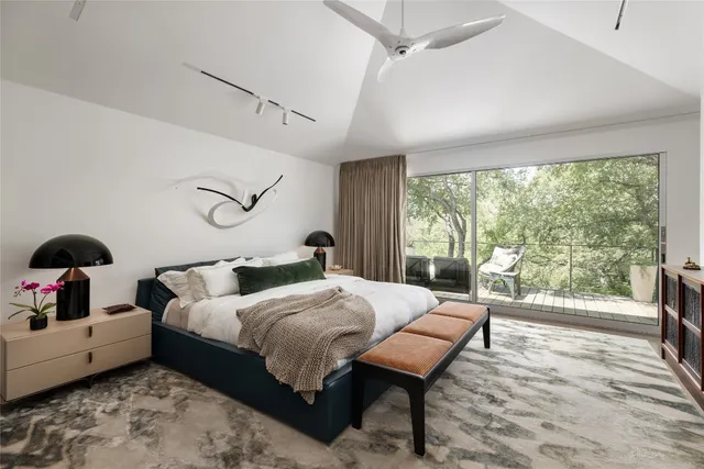 a bedroom with a large bed and a window