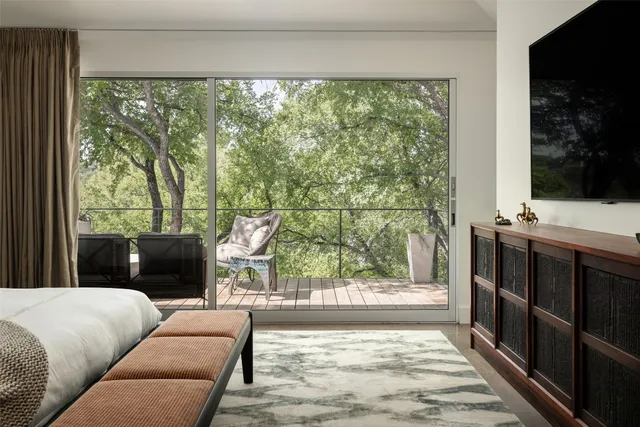 a room with a chandelier furniture and wooden floor