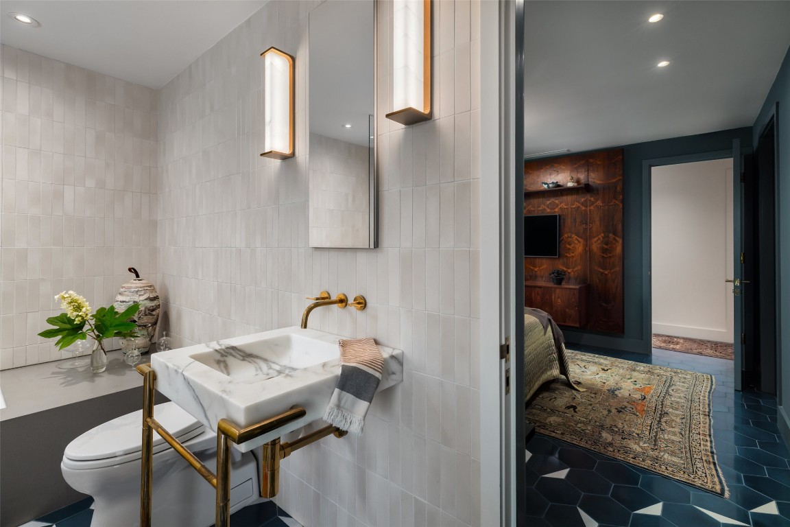 2908 Scenic Drive Austin, TX 78703 - Photo 32 of 40 a en suite bathroom with a granite countertop sink and a mirror