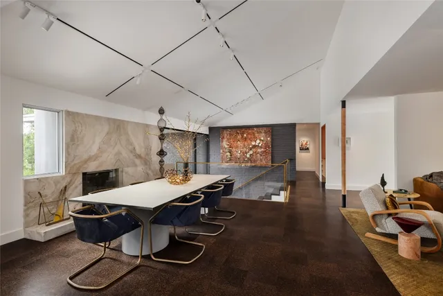 a kitchen with a table chairs and a wooden floor