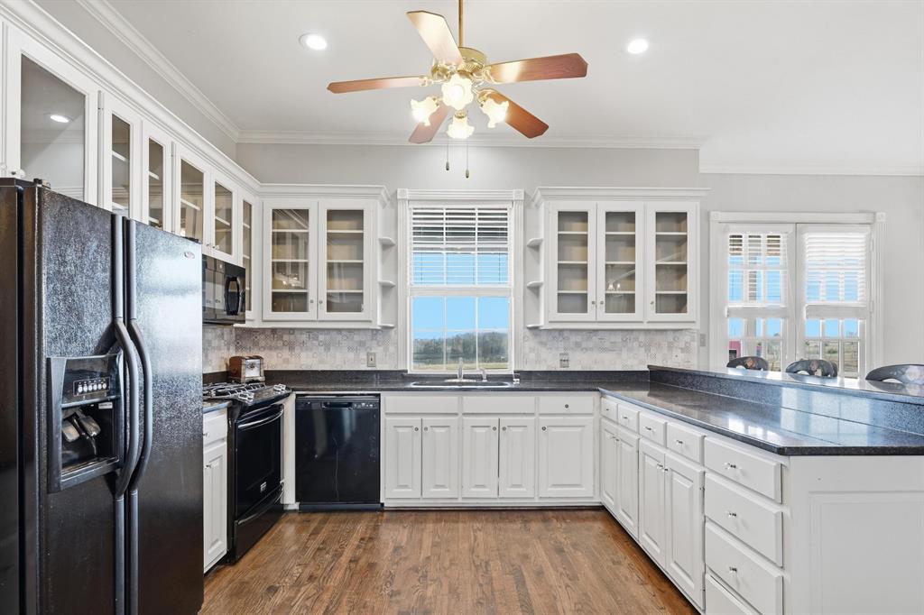 707 Cullins Road Rockwall, TX 75032 - Photo 12 of 40 a kitchen with stainless steel appliances granite countertop a sink a stove and refrigerator