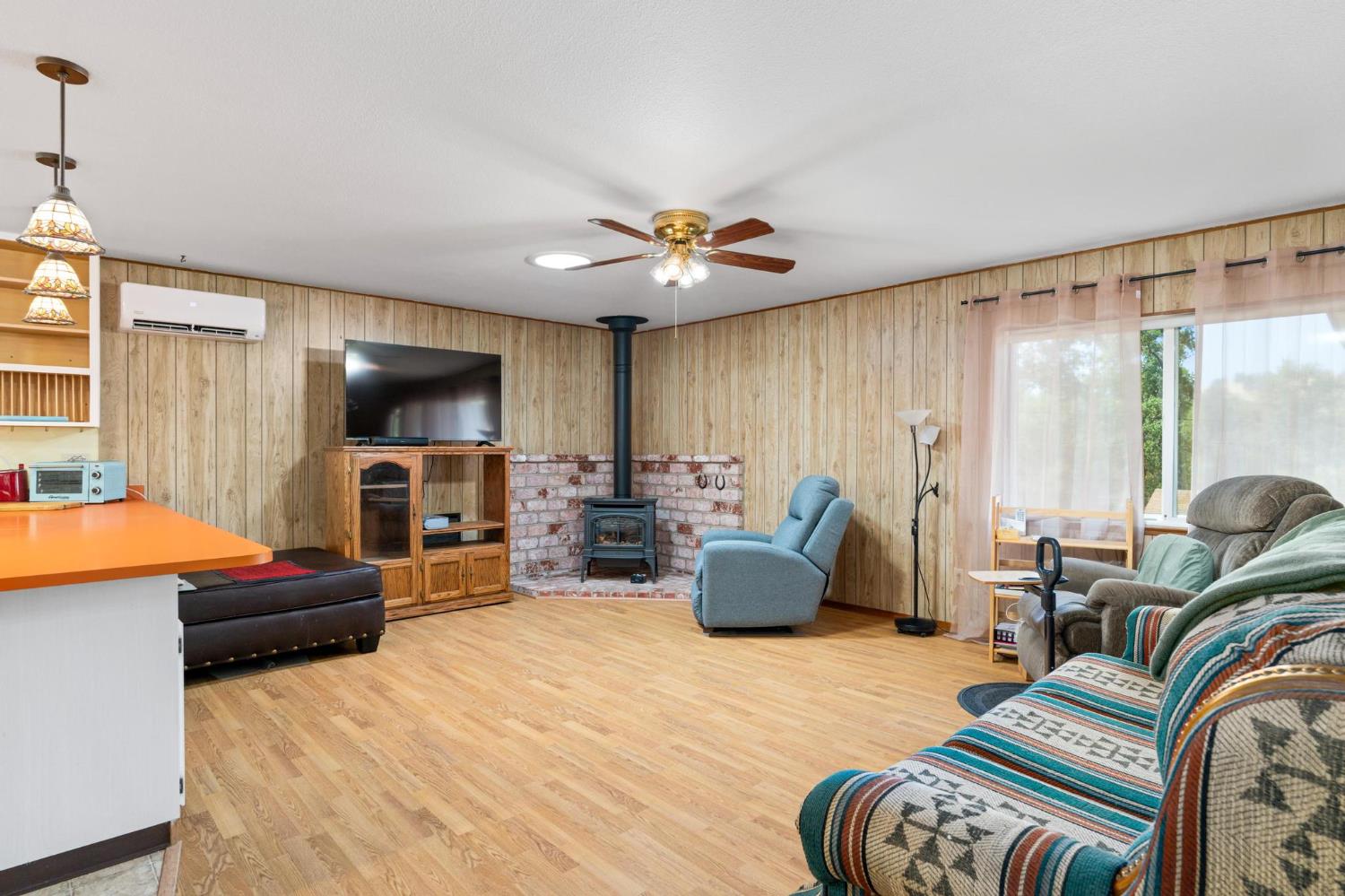 18490 Railbed Road Jamestown, CA 95327 - Photo 15 of 53 a living room with furniture a flat screen tv and floor to ceiling window