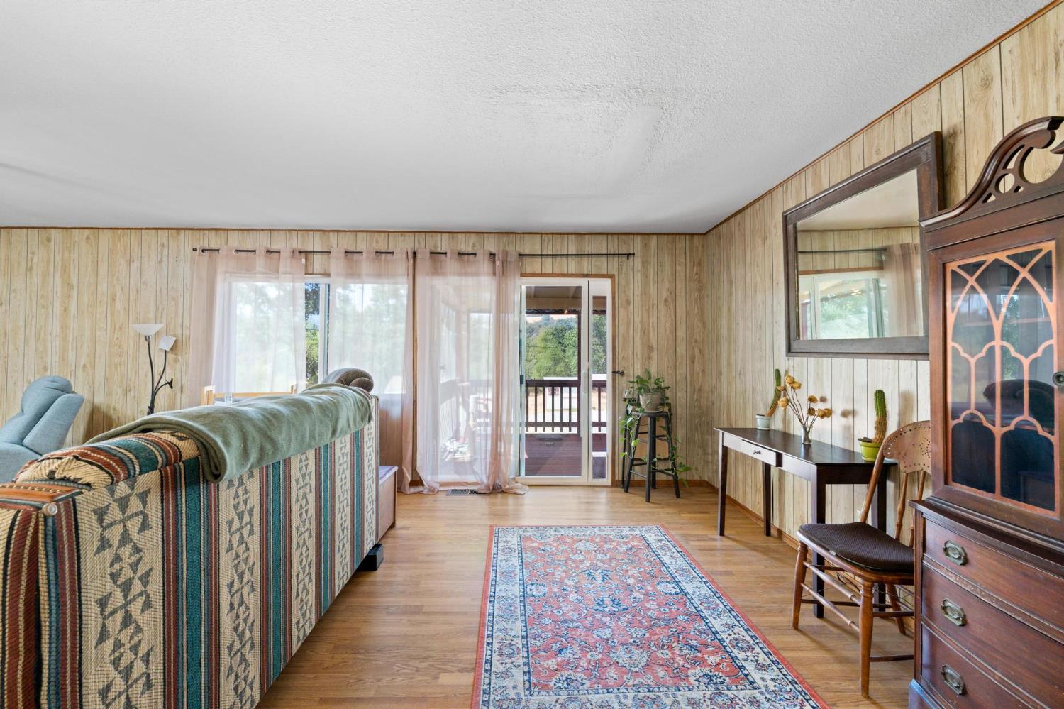 18490 Railbed Road Jamestown, CA 95327 - Photo 18 of 53 a living room with furniture and a floor to ceiling window