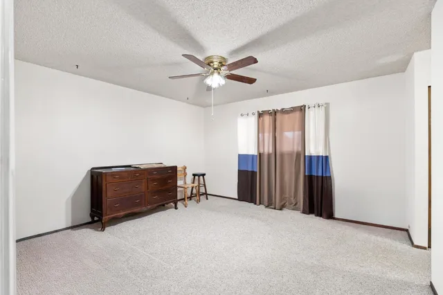 a view of a hallway with wooden shelves