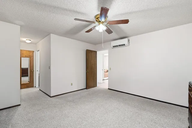 a bedroom with a bed and a ceiling fan