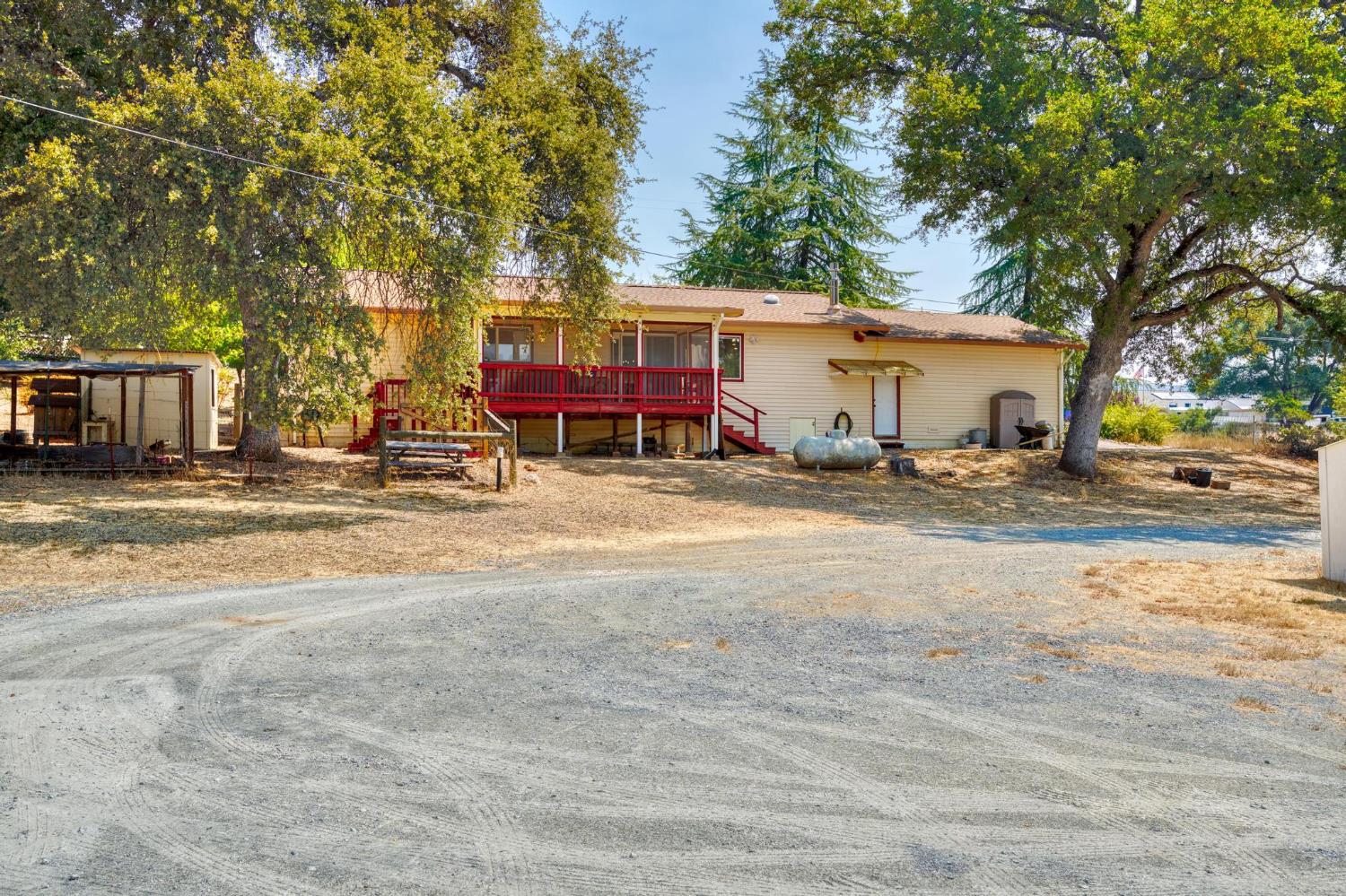 18490 Railbed Road Jamestown, CA 95327 - Photo 37 of 53 a view of a house with a patio