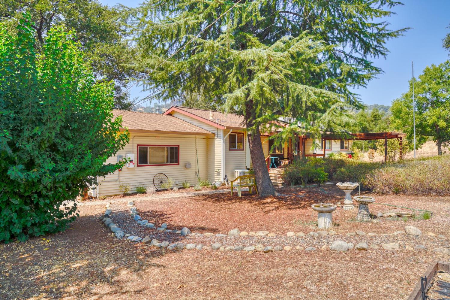 18490 Railbed Road Jamestown, CA 95327 - Photo 7 of 53 a front view of a house with a yard and a garage