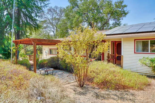 a backyard of a house with table and chairs