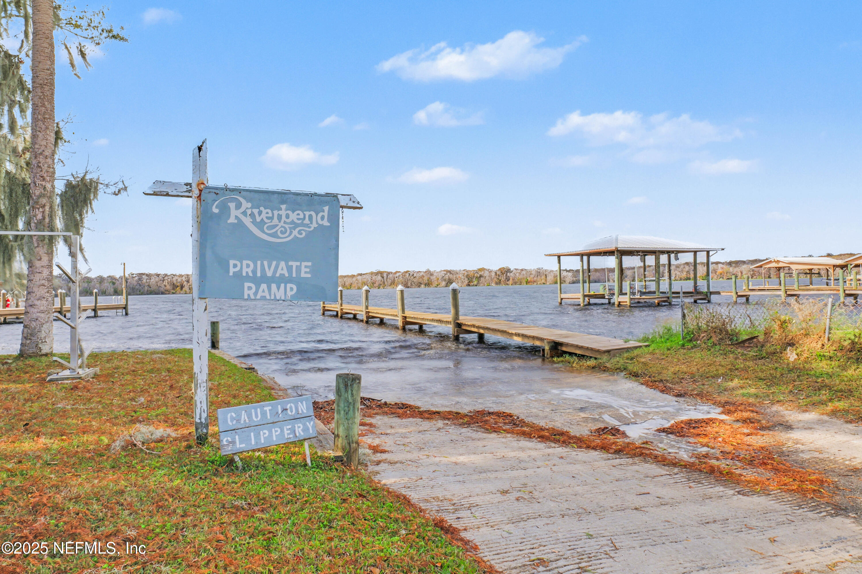 102 River Bend Road, Unit A Welaka, FL 32193 - Photo 11 of 39 a swimming pool with outdoor seating and yard in the back